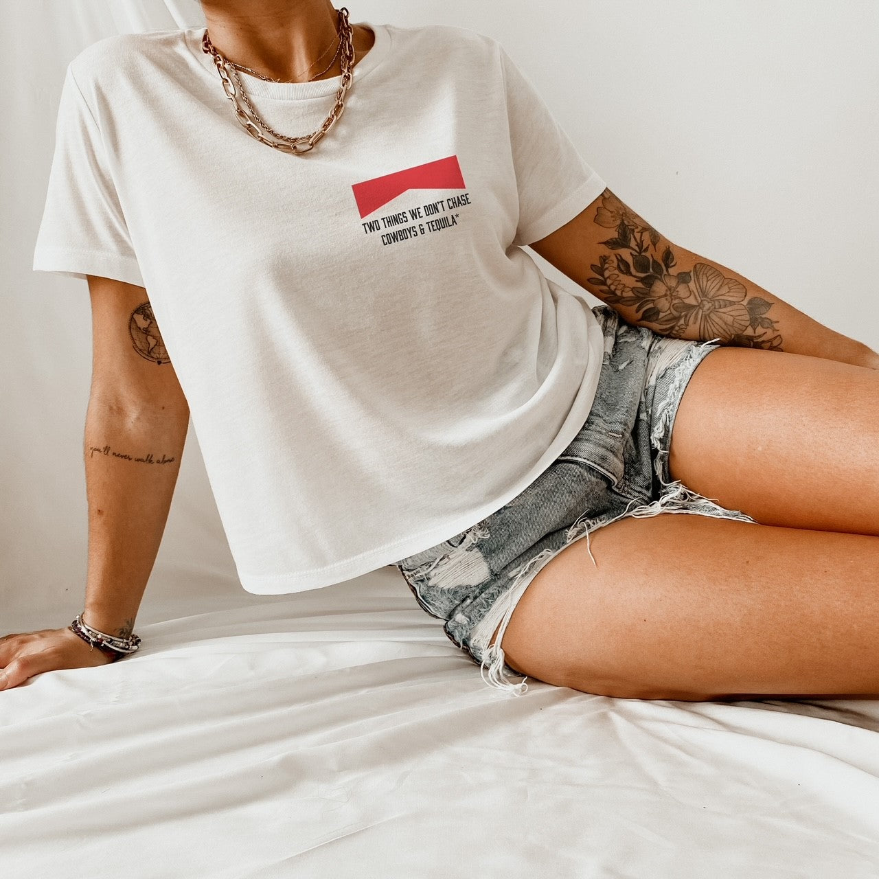 Two Things We Don't Chase Cowboys & Tequila* ™  Standard White Crop Tee